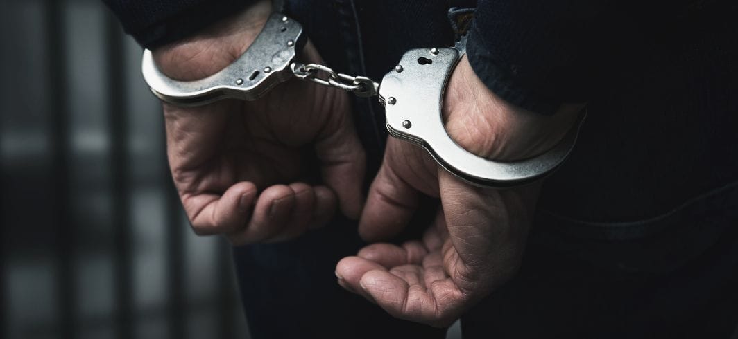 a man in hand cuffs concept civil liberties false imprisonment client