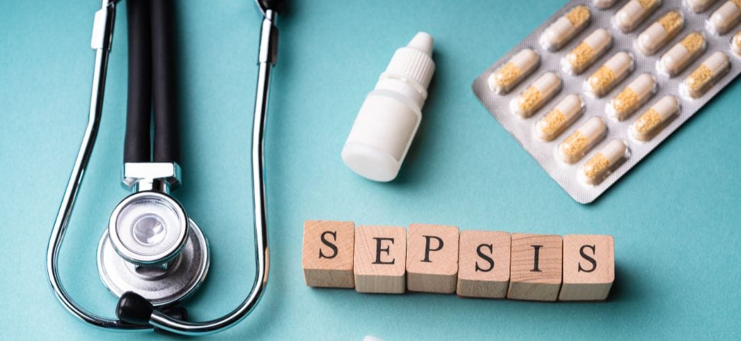 wooden blocks spelling out sepsis accompanied by a stethoscope tablets and drops concept medical negligence misdiagnosis sepsis negligence client