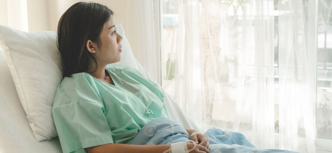 woman sat in a hospital bed concept medical negligence hospital negligence client