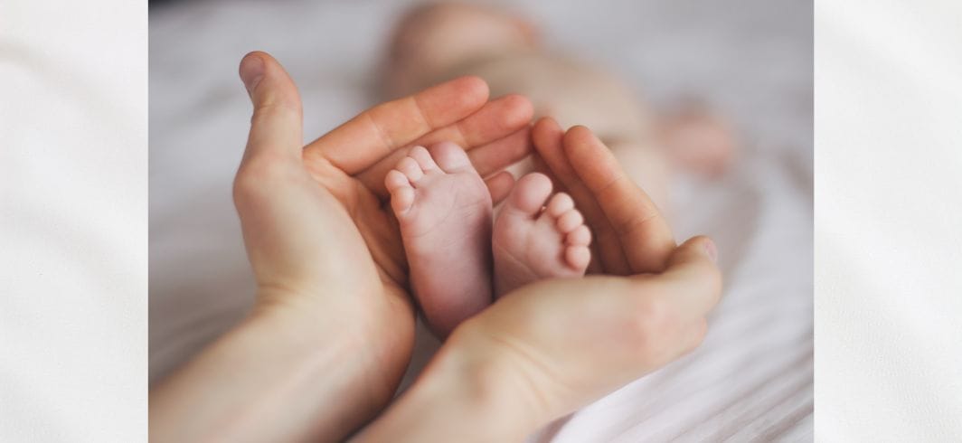 parent cupping the babys feet concept medical negligence pregnancy and birth injury client