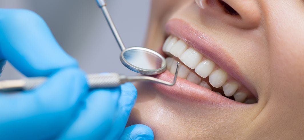 woman having her teeth checked by a dentist concept medical negligence dental negligence client