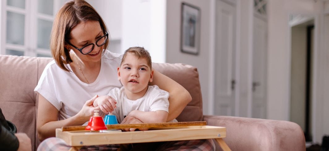 a mother is engaged in a music lesson with her child with cerebral palsy concept representing medical negligence cerebral palsy compensation claims