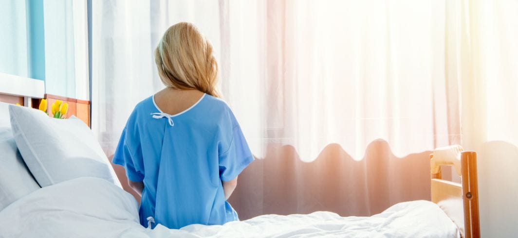 woman in bed concept medical negligence hospital negligence mini image