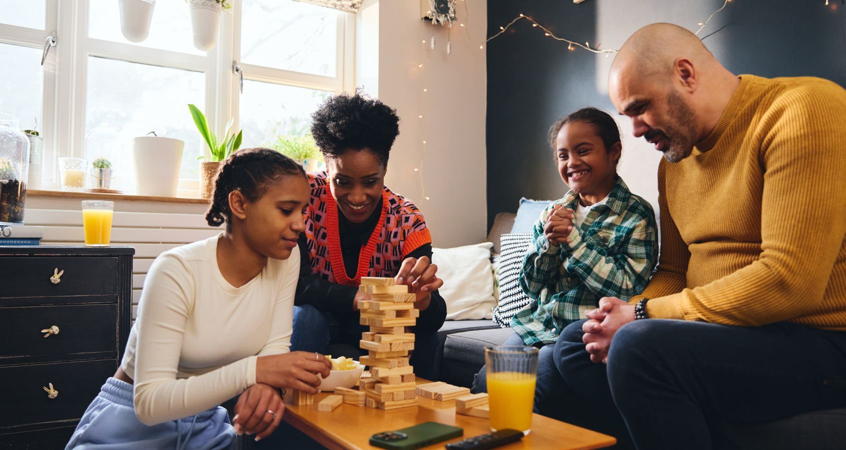 boy-with-down-syndrome-playing-board-game-with-family-at-home-concept-court-of-protection-deputyships-statutory-wills-lasting-power-of-attorney-hero-banner