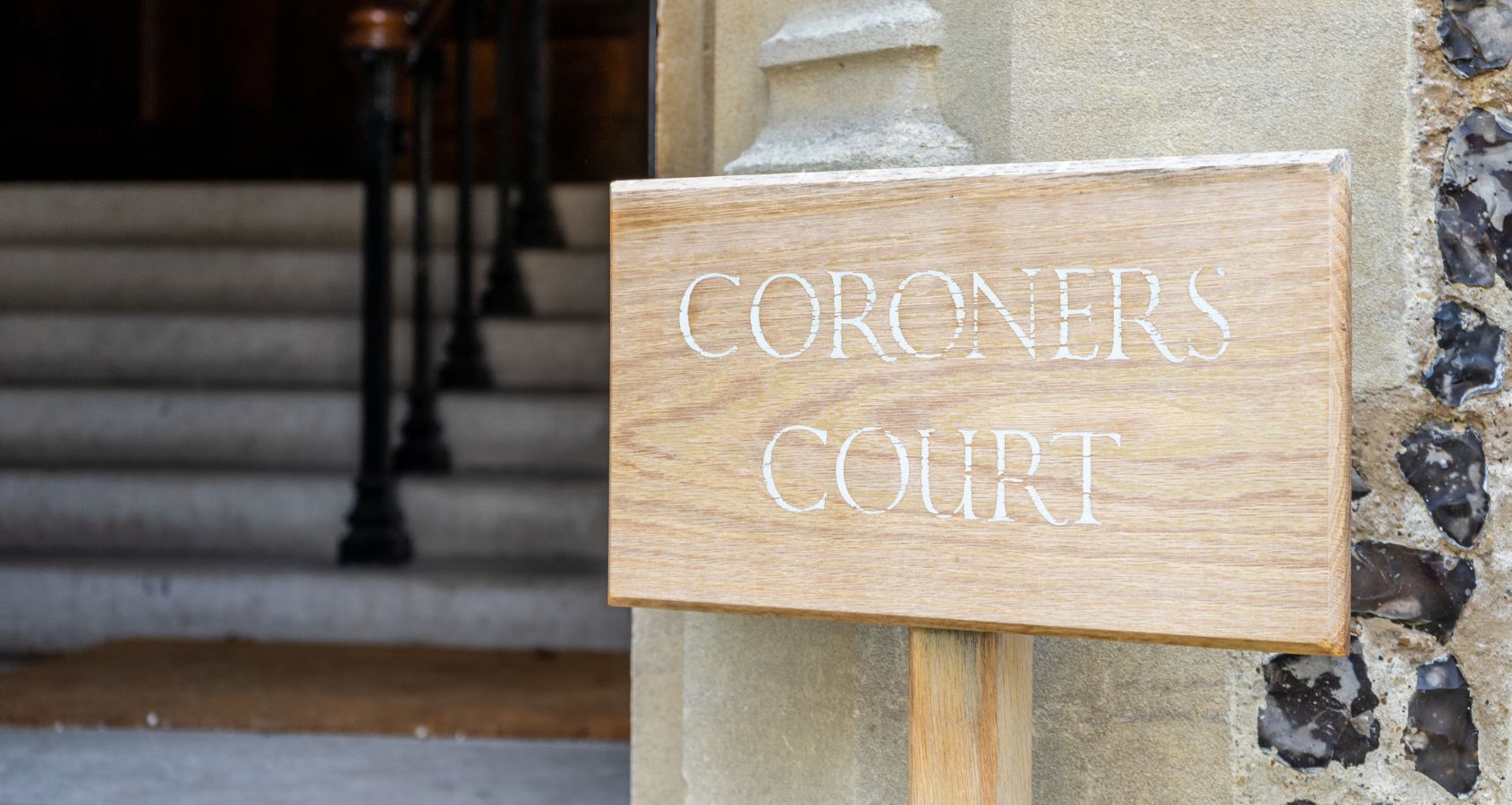 a wooden sign showing the words coroners office concept representing civil liberties death in custody compensation claims