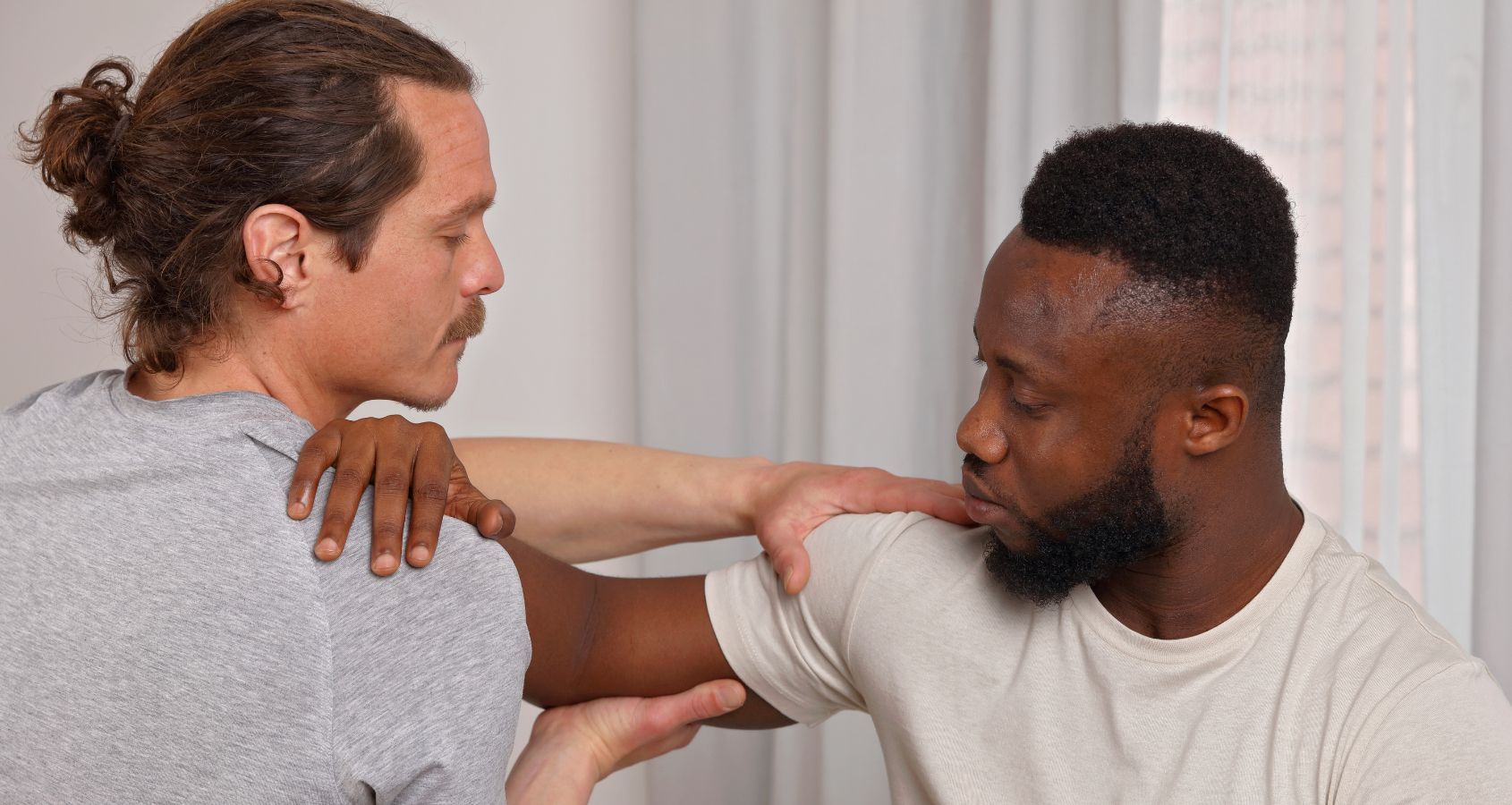black man assessed for brachial plexus injury using physical examination of shoulder area representing brachial plexus compensation claims