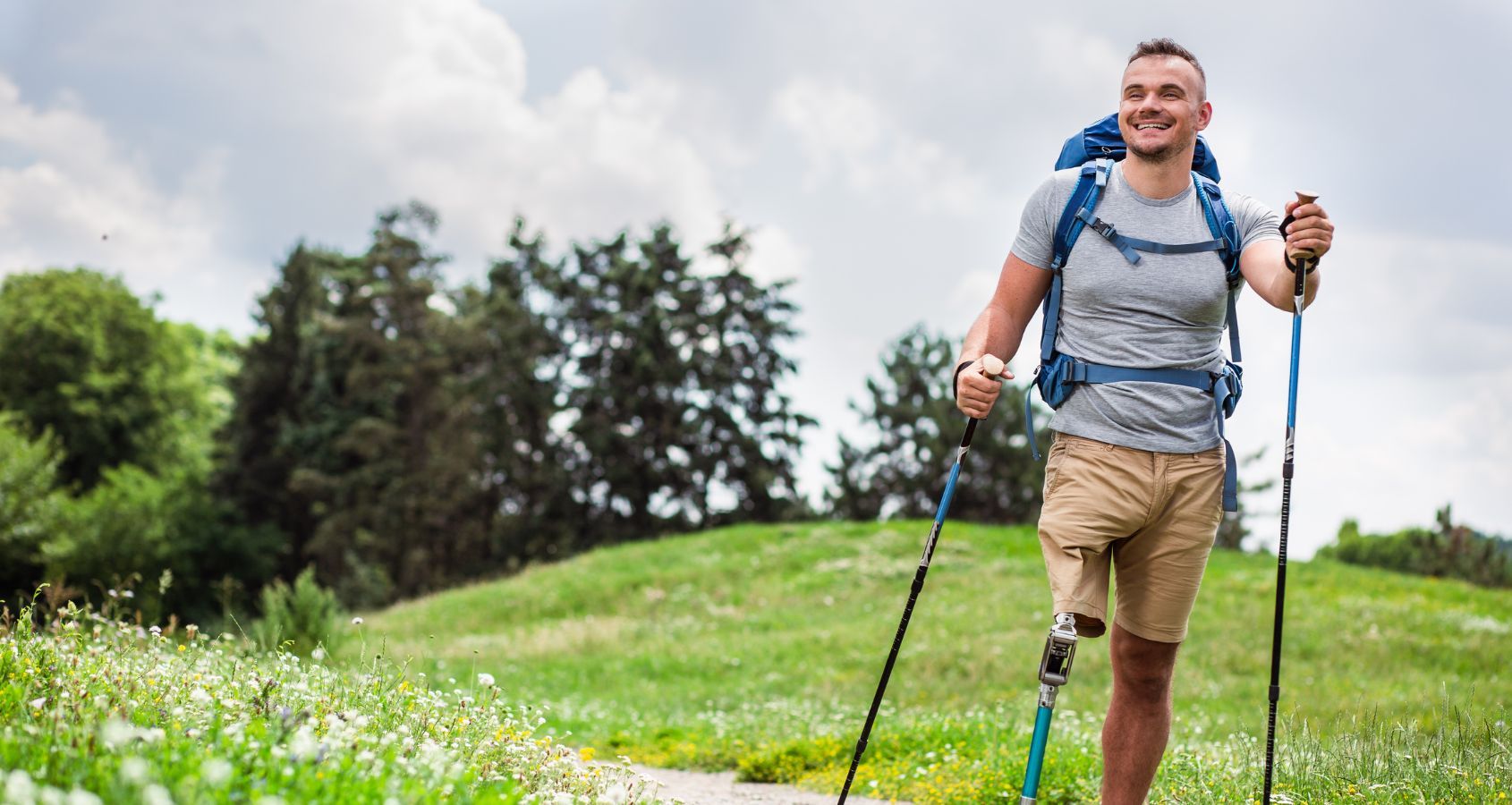 happy-young-man-with-disability-trying-nordic-walking-representing-amputation-compensation-claims
