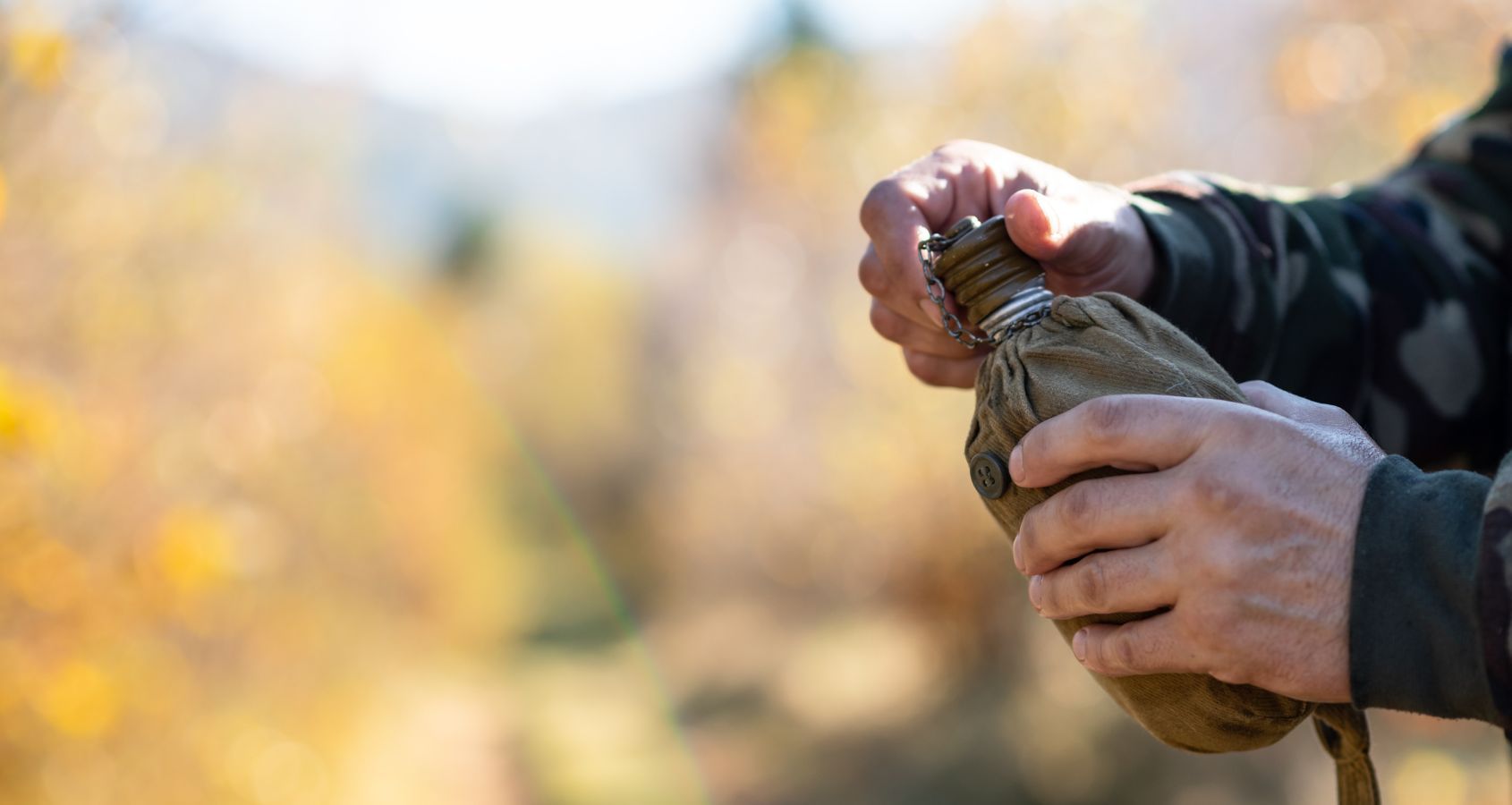 military-man-holding-a-water-canteen-representing-camp-lejeune-compensation-claims