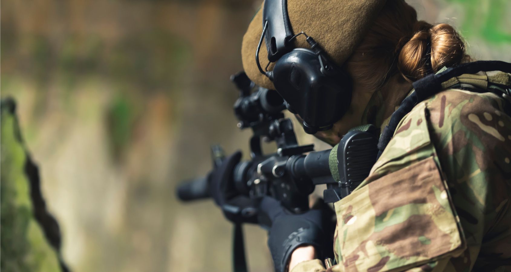 female-military-army-soldier-aiming-rifle-wearing-ear-defenders-concept-military-hearing-loss-claims-military-injury-compensation-solicitors