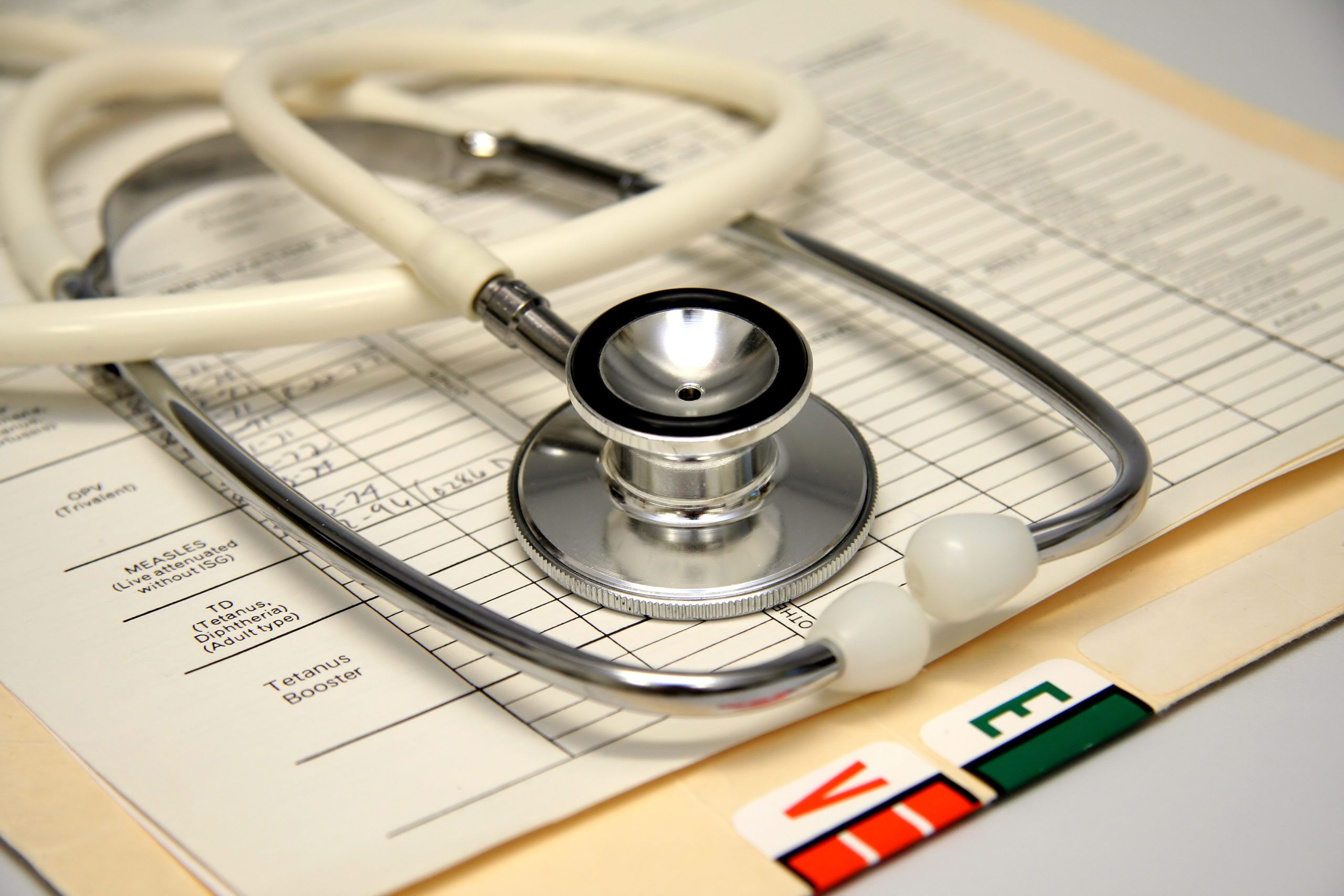 white stethoscope on a medical chart