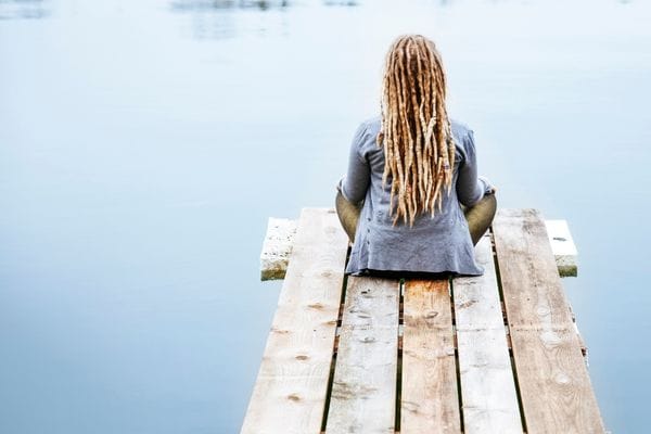 Anonymous woman sitting at a lake