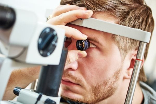 man having an eyesight examination by a medical professional