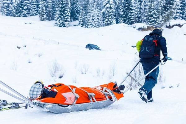 skier being taken off the piste following a skiing accident