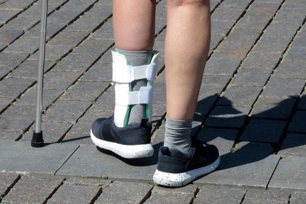 woman using walking aid and support due to foot injury
