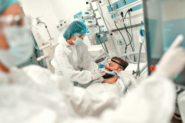 doctors-treating-a-sick-man-with-coronavirus-disease-covid-19-in-intensive-care-unit-representing-covid-public-inquiry-group-action-compensation-claims