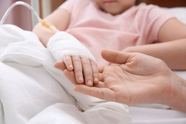 doctor-holding-little-childs-hand-with-intravenous-drip-in-hospital-concept-representing-medical-negligence-sepsis-compensation-claims