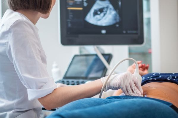 pregnant woman on utltrasonographic examination at hospital concept representing medical negligence stillbirth and neonatal compensation claims
