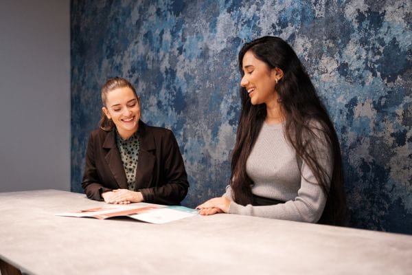 hudgell-solicitors-staff-members-chatting-and-smiling-at-table-in-the-office