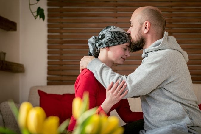 supportive-husband-kissing-wife-cancer-patient
