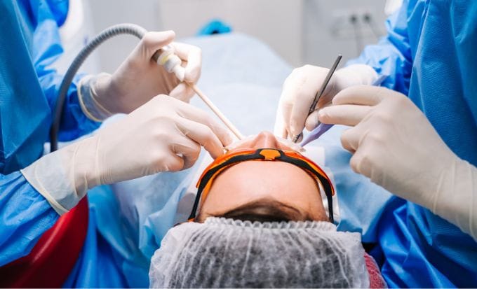 dentist in uniform perform dental treatment on a patient concept medical negligence dental negligence compensation claims