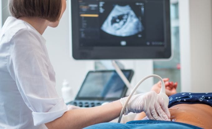 pregnant woman on utltrasonographic examination at hospital concept ectopic pregnance medical negligence claim