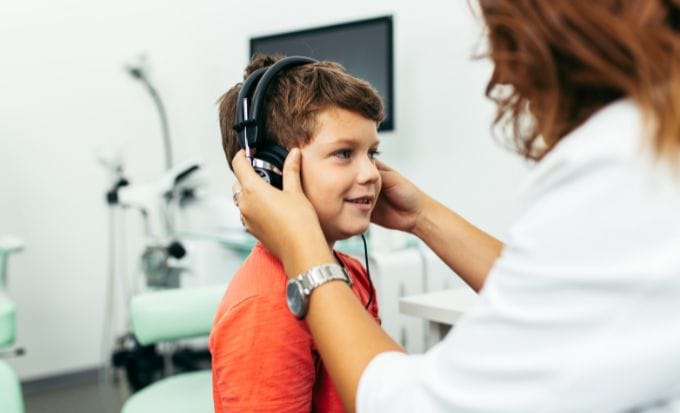 boy having his ears tested concept medical negligence child medical negligence feature