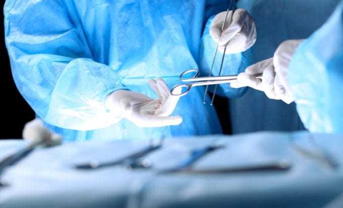 medical team performing operation. group of surgeon is working in operating theatre toned in blue concept medical negligence hospital negligence feature image