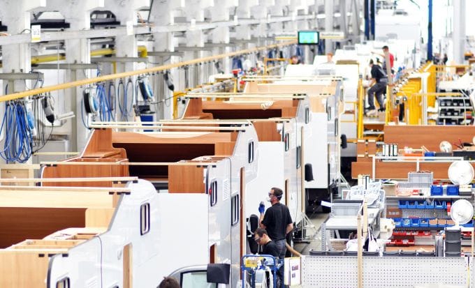 caravan factory showing workers and caravans being built concept personal injury accidents at work