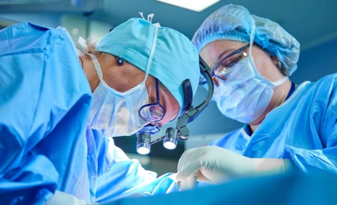 two surgeons taking part in surgery concept medical negligence never event claims feature