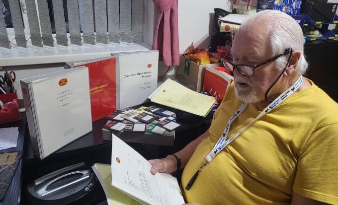 ken tooby looking at his wife’s post office files concept group actions post office capture feature
