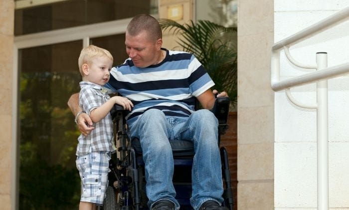 man-in-wheelchair-hugs-son-concept-representing-personal-injury-compensation-claims