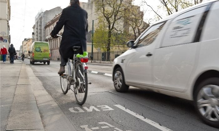 bike on bike path on busy road with traffic concept representing personal injurycycling accident compensation claims