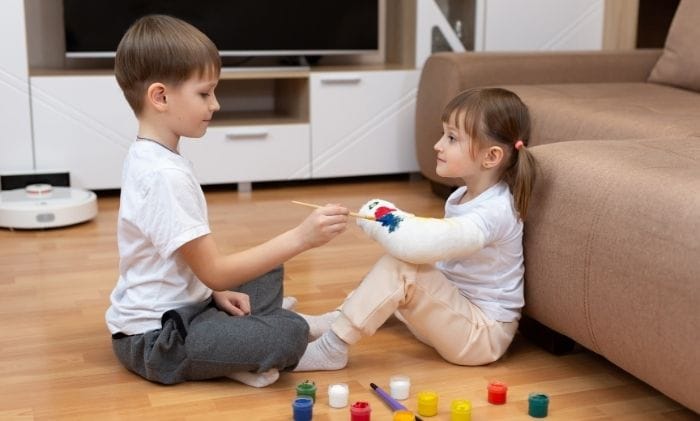 children drawing on plaster bandages on arm concept representing personal injury child injury compensation compensation claims