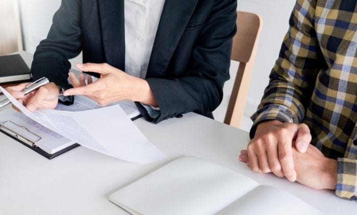 closeup solicitor discussing documents at desk concept representing medical negligence medical negligence concerns compensation claims