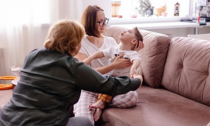 family with a child with cerebral palsy occupy with a rehabilitation therapist concept representing medical negligence cerebral palsy compensation claims