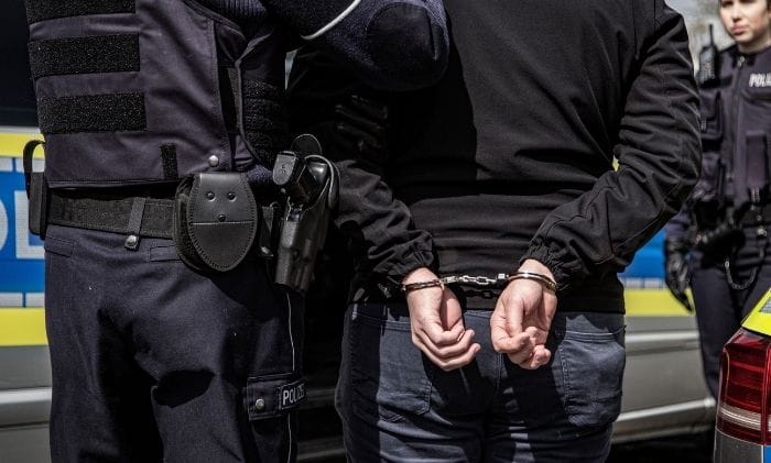 person-arrested-by-police-handcuffed-behind-back-concept-representing-civil-liberties-wrongful-arrest-compensation-claims