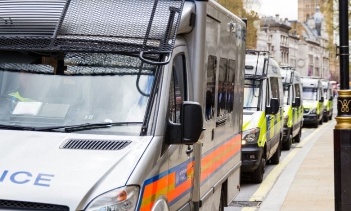police vans in a row concept representing civil liberties false imprisonment compensation claims