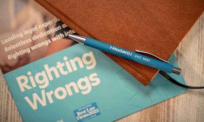 righting wrongs brochure with pen representing contact hudgell solicitors no win no fee compensation claims