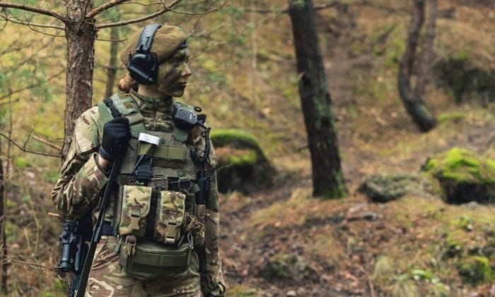 british-armed-military-forces-female-soldier-stood-in-woods-concept-military-hearing-loss-claims-military-injury-compensation-solicitors