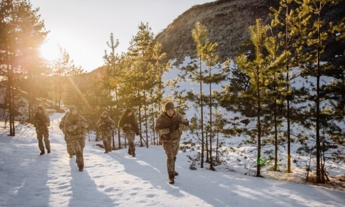 team-of-special-forces-weapons-walking-through-freezing-cold-forest-winter-warfare-concept-military-non-freezing-cold-injuries-compensation-military-injury-compensation-solicitors