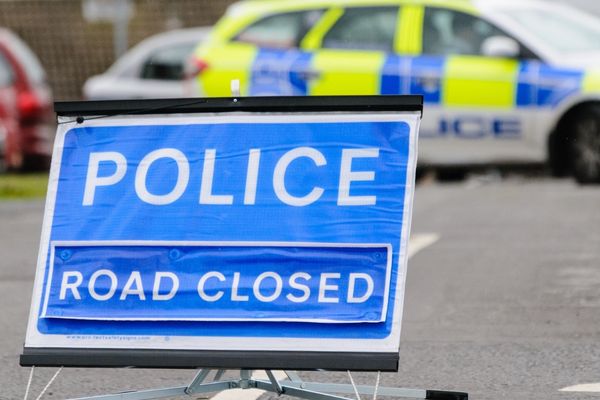 police road closure sign following an accident